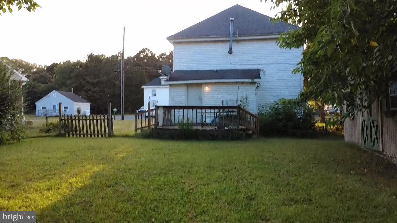 7313 Canal Street Willards, MD 21874 - Photo 2 of 3 a view of a house with a yard and deck