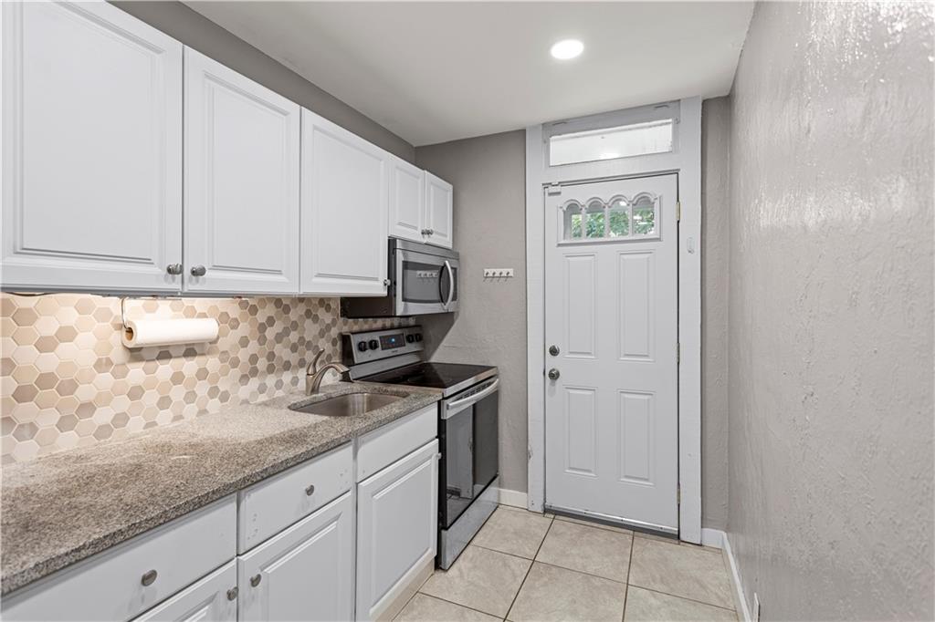 4048 Franklin Road Pittsburgh, PA 15214 - Photo 11 of 25 a kitchen with granite countertop white cabinets and stainless steel appliances