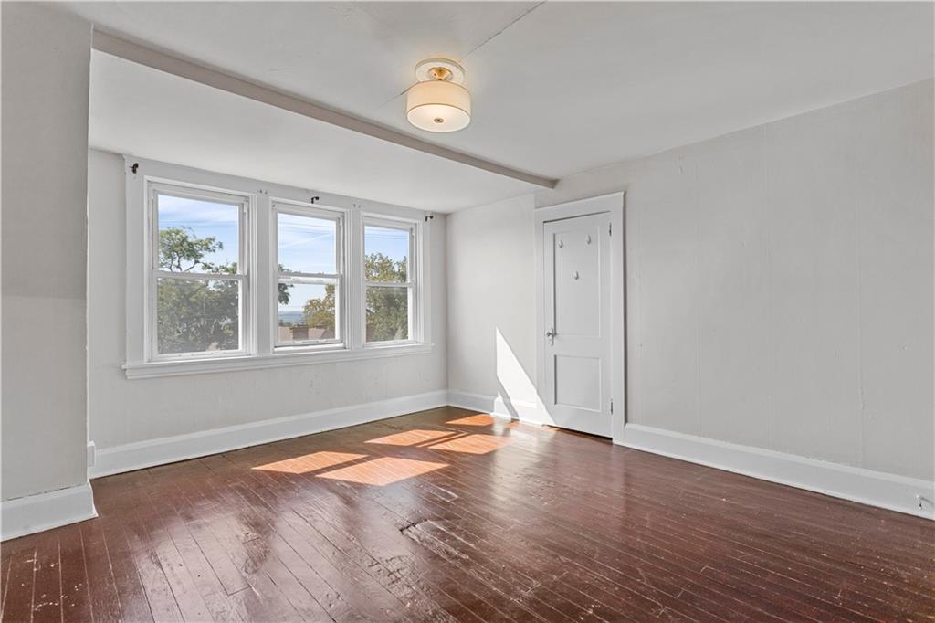 4048 Franklin Road Pittsburgh, PA 15214 - Photo 17 of 25 a view of an empty room with wooden floor and a window