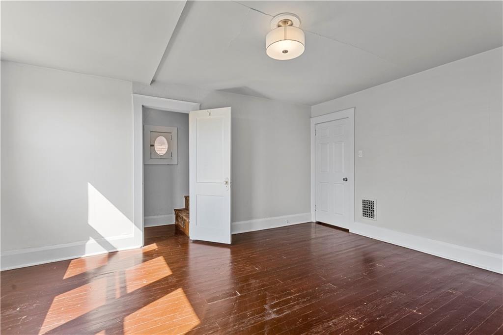 4048 Franklin Road Pittsburgh, PA 15214 - Photo 18 of 25 a view of an empty room with wooden floor and a window