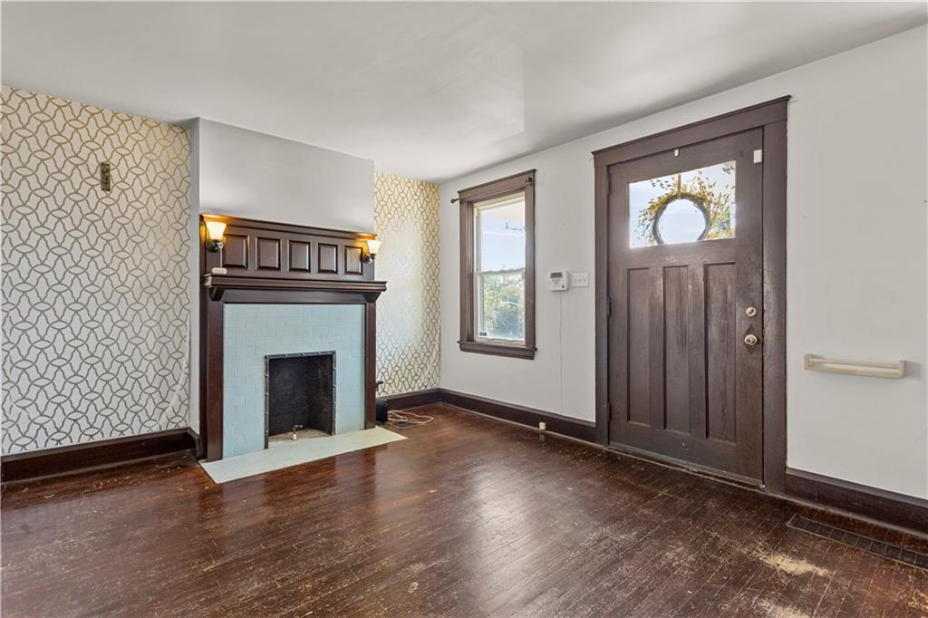 4048 Franklin Road Pittsburgh, PA 15214 - Photo 5 of 25 an empty room with windows fireplace and wooden floor