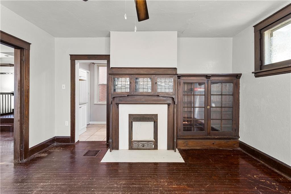 4048 Franklin Road Pittsburgh, PA 15214 - Photo 9 of 25 a view of a hallway with wooden floor a fireplace and a window