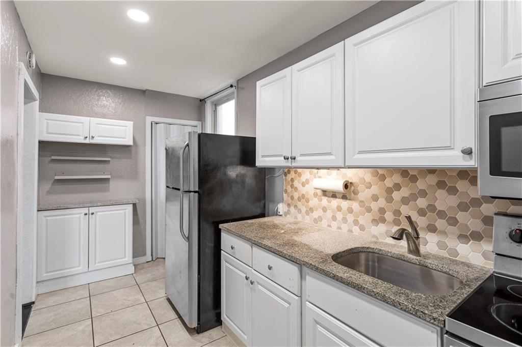 4048 Franklin Road Pittsburgh, PA 15214 - Photo 10 of 25 a kitchen with a sink and a refrigerator