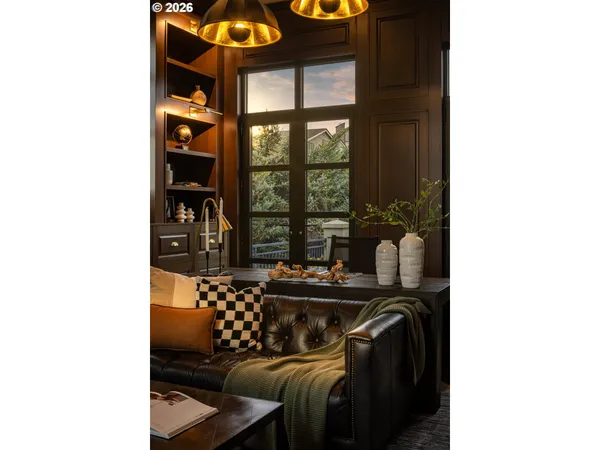 a living room with furniture and floor to ceiling windows