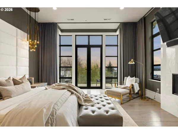 a bedroom with a large bed and a large window