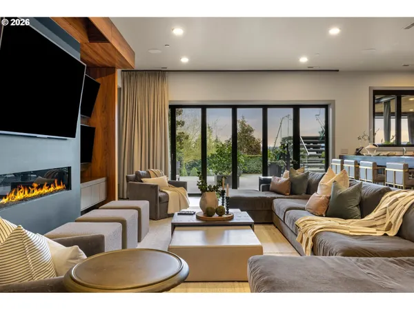a living room with furniture large window and flat screen tv
