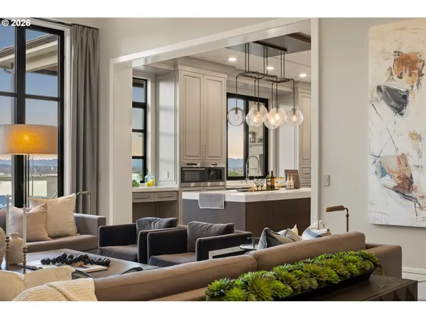 a living room with furniture and a chandelier