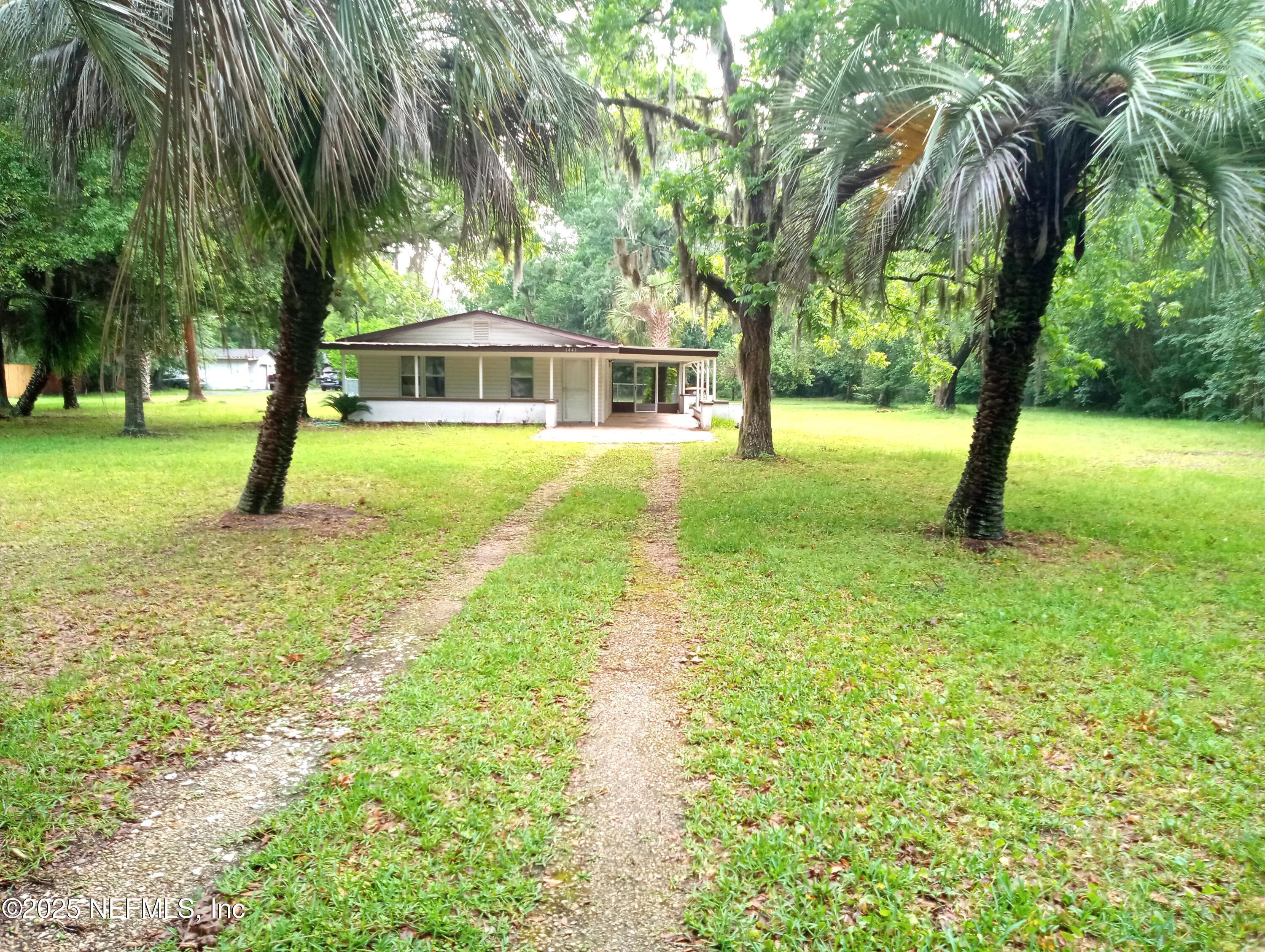 a view of a house with a yard