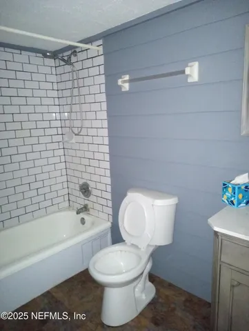 a bathroom with a toilet and a bathtub