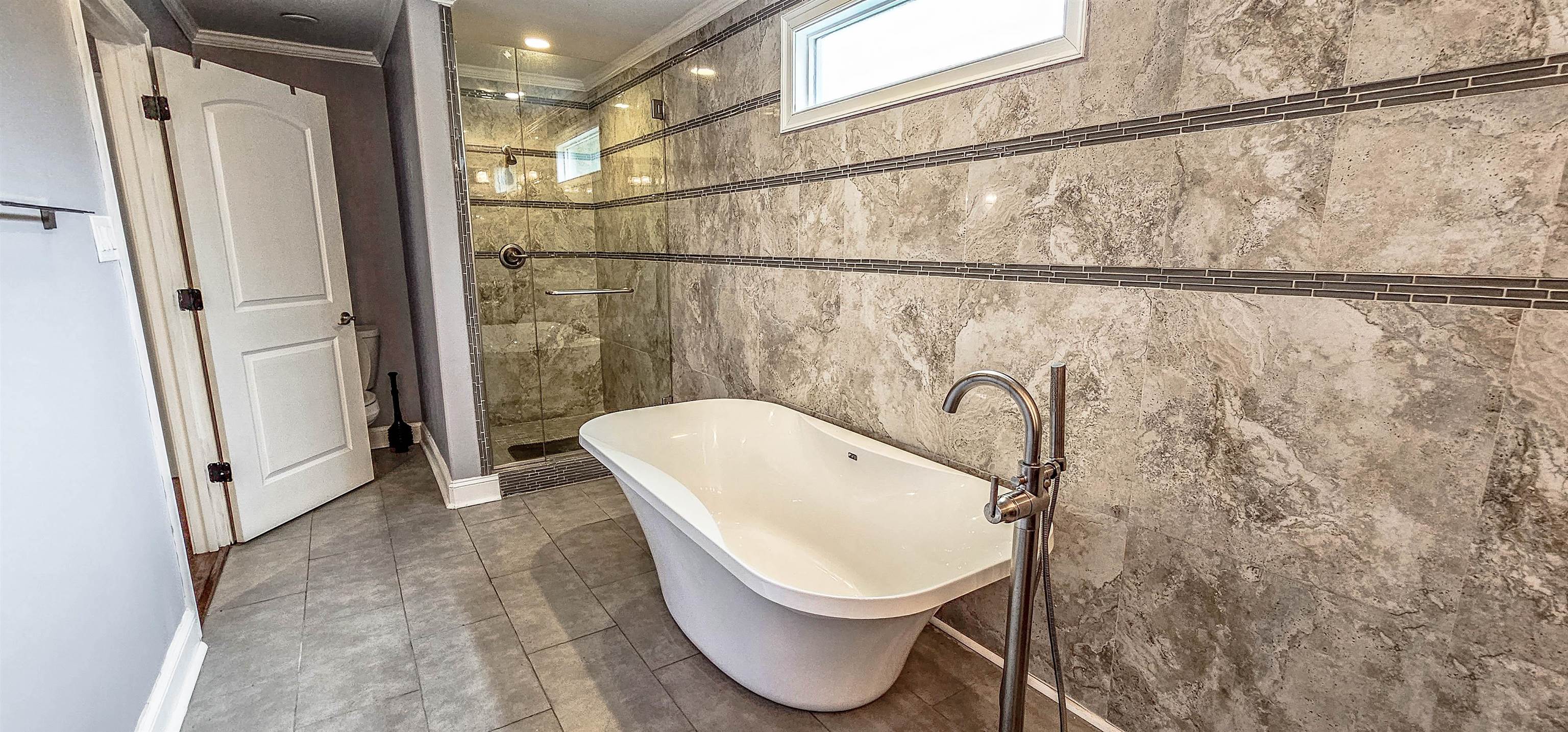 461 South White Station Road Memphis, TN 38117 - Photo 15 of 26 Enjoy relaxing in the large soaking tub surrounded by a wall of custom tile.