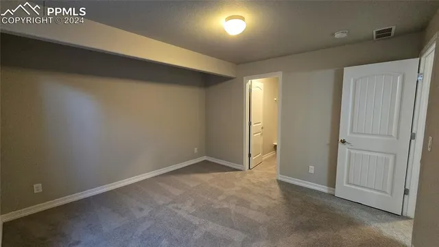 an empty room with windows and closet