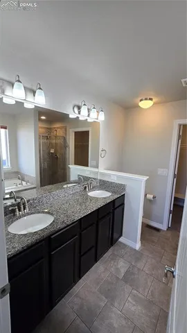 an empty room with ceiling fan and windows