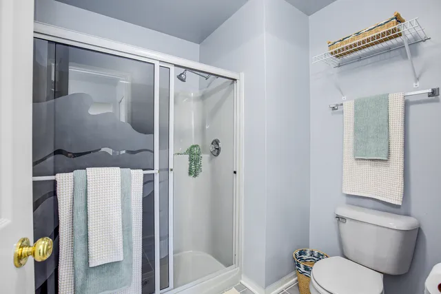 a white toilet sitting next to a bathroom sink