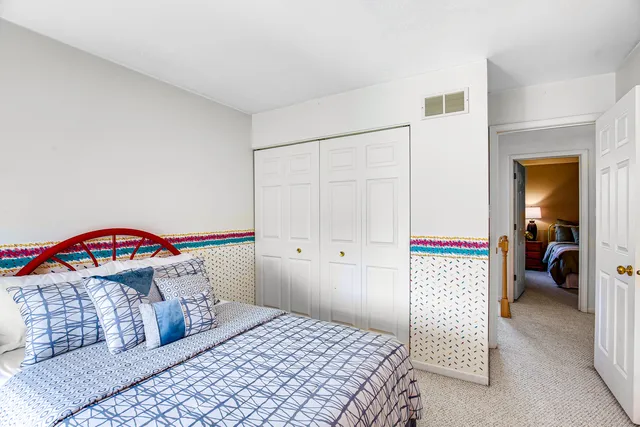 a bedroom with a bed and a book shelf