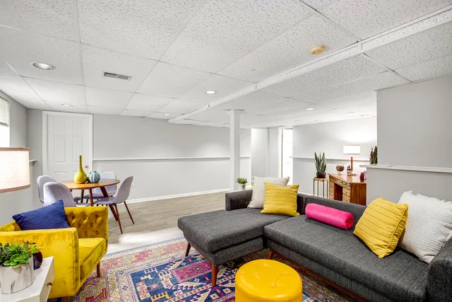 a living room with furniture and kitchen view