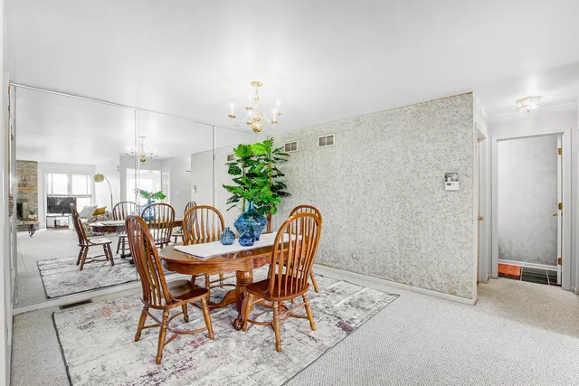 a view of a dining room with furniture and a potted plant