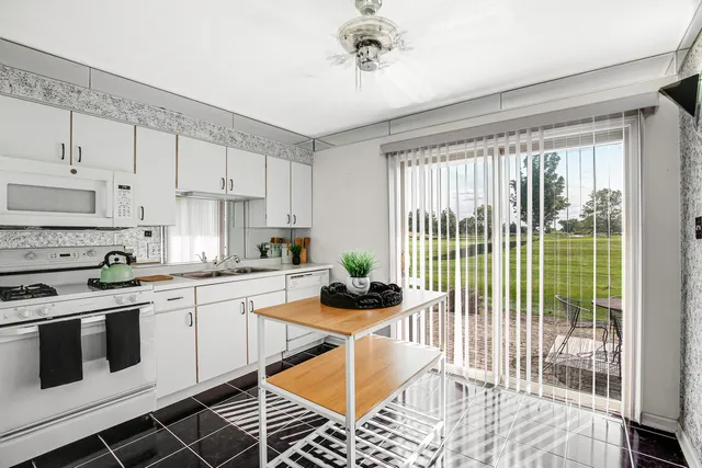 a kitchen with stainless steel appliances a stove a sink and cabinets