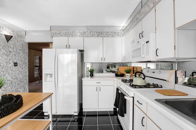 a kitchen with a sink a stove and refrigerator