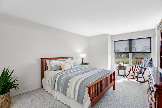 a bedroom with a bed a balcony and furniture