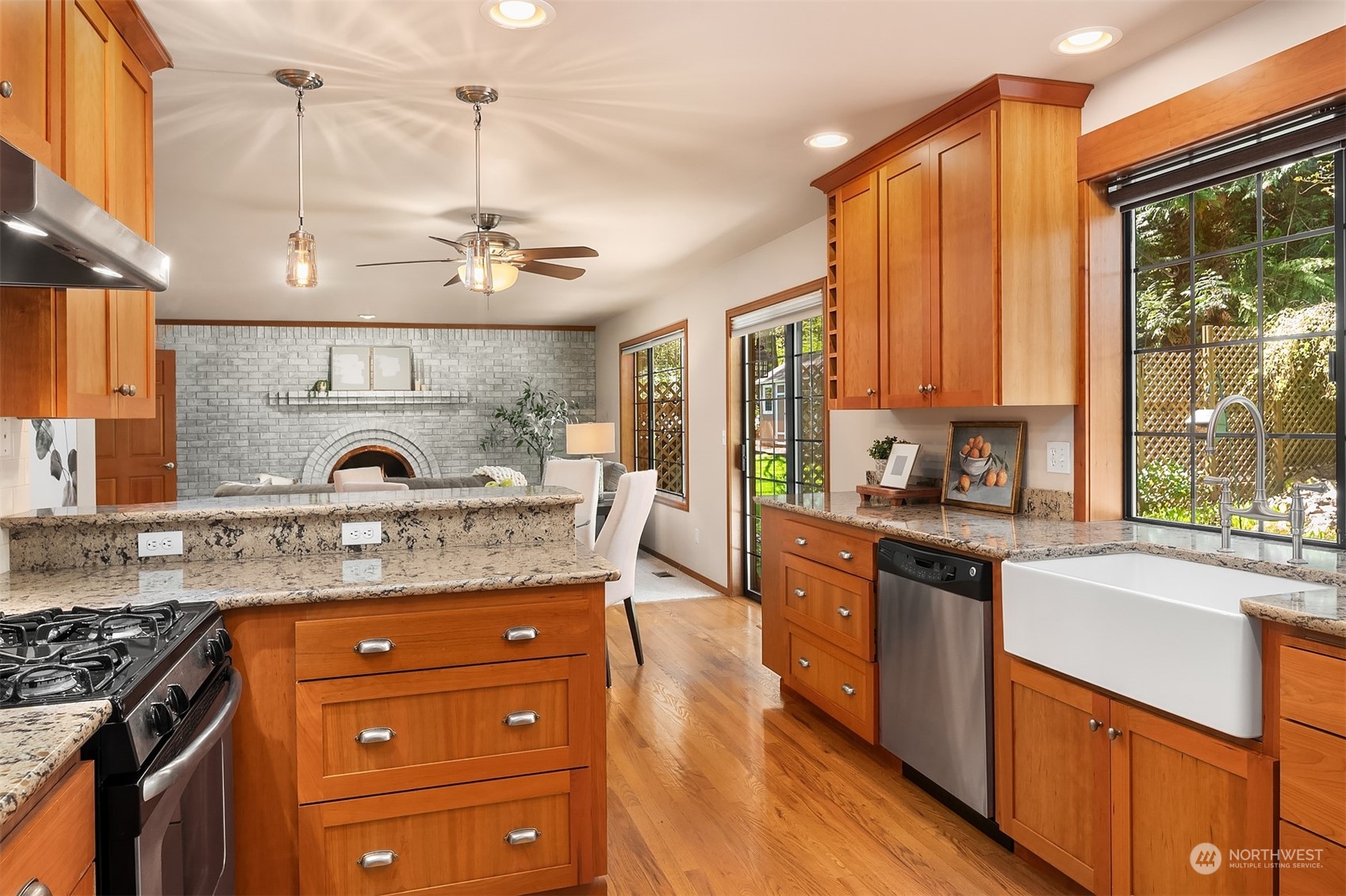 121 173rd Place Southeast Bothell, WA 98012 - Photo 13 of 39 a kitchen with stainless steel appliances granite countertop a stove a sink and a wooden cabinets