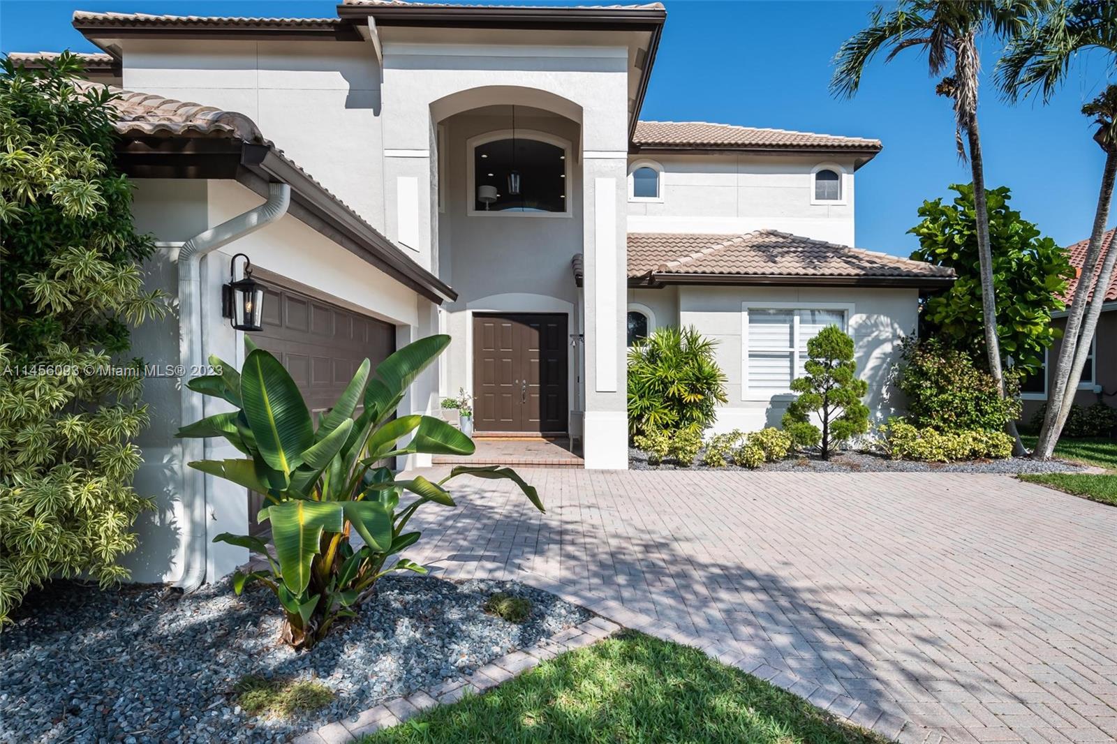 10633 Northwest 62nd Court Parkland, FL 33076 - Photo 1 of 45 a view of a house with potted plants