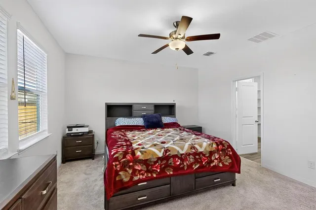 a bedroom with a bed and a window