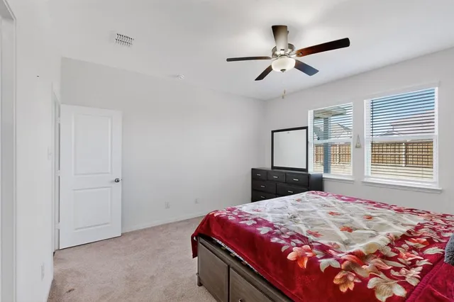 a bedroom with a bed and window