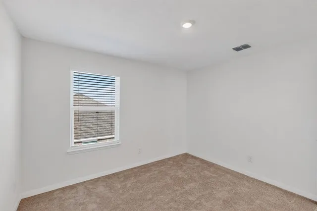 a view of wooden floor and a chandelier fan in a room