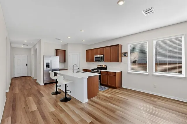 a view of kitchen with sink microwave and stove