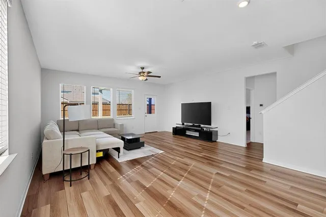a kitchen that has a sink and a stove with wooden floor