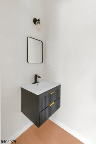 a bathroom with a sink a mirror and vanity