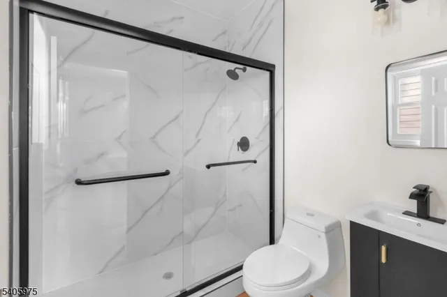 a white toilet sitting next to a bathroom sink