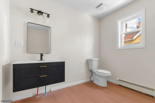 a bathroom with a sink a toilet and mirror