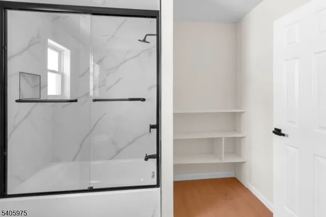 a bathroom with a bathtub and a shower