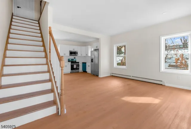 a view of empty room with stairs and furniture