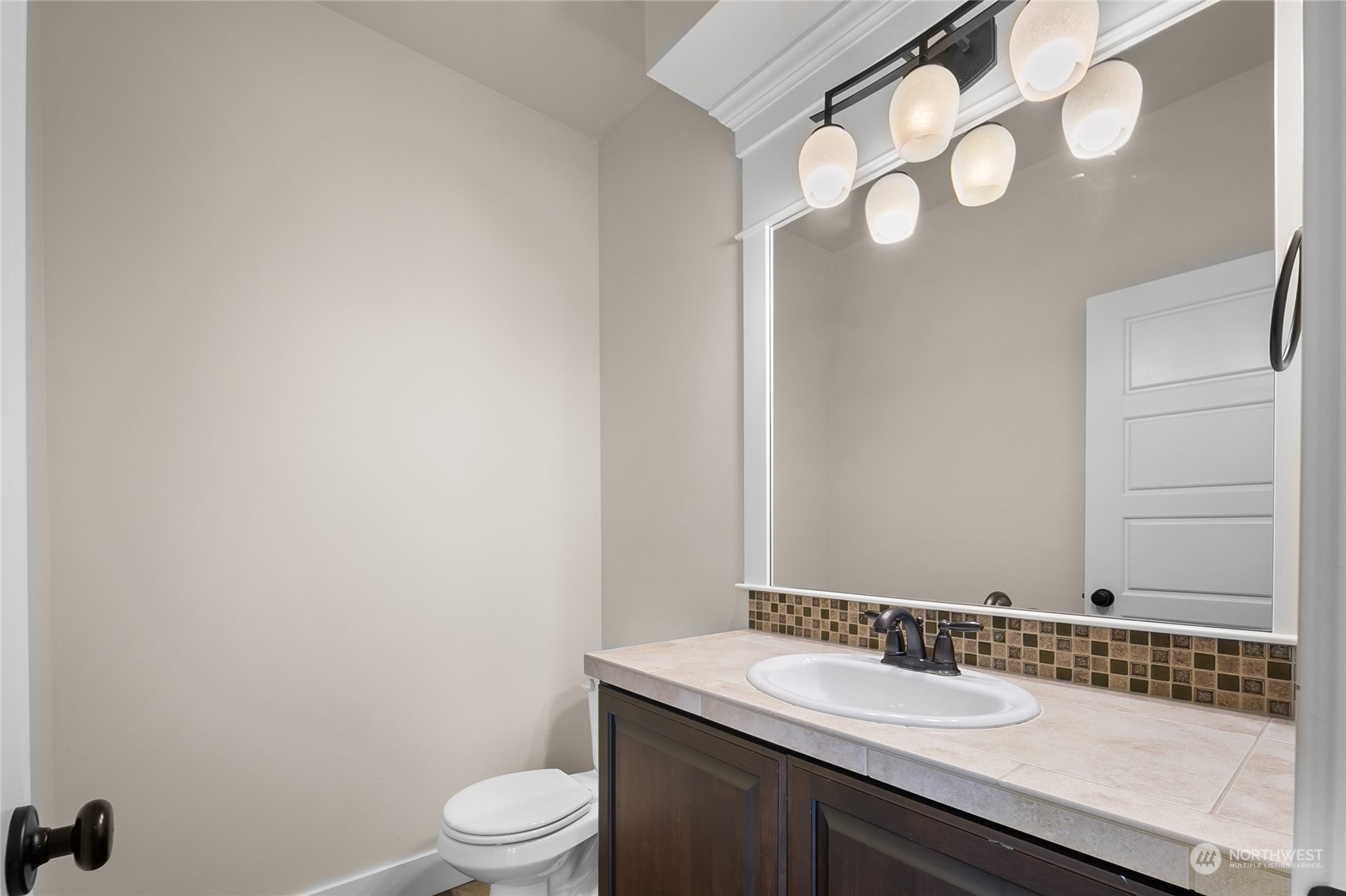 3110 216th Place Southeast Bothell, WA 98021 - Photo 12 of 37 a bathroom with a granite countertop sink a toilet and a mirror