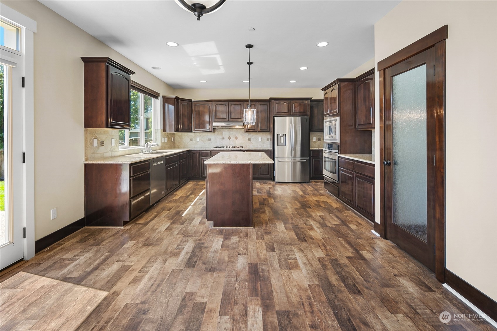 3110 216th Place Southeast Bothell, WA 98021 - Photo 14 of 37 a large kitchen with kitchen island a sink stainless steel appliances and cabinets