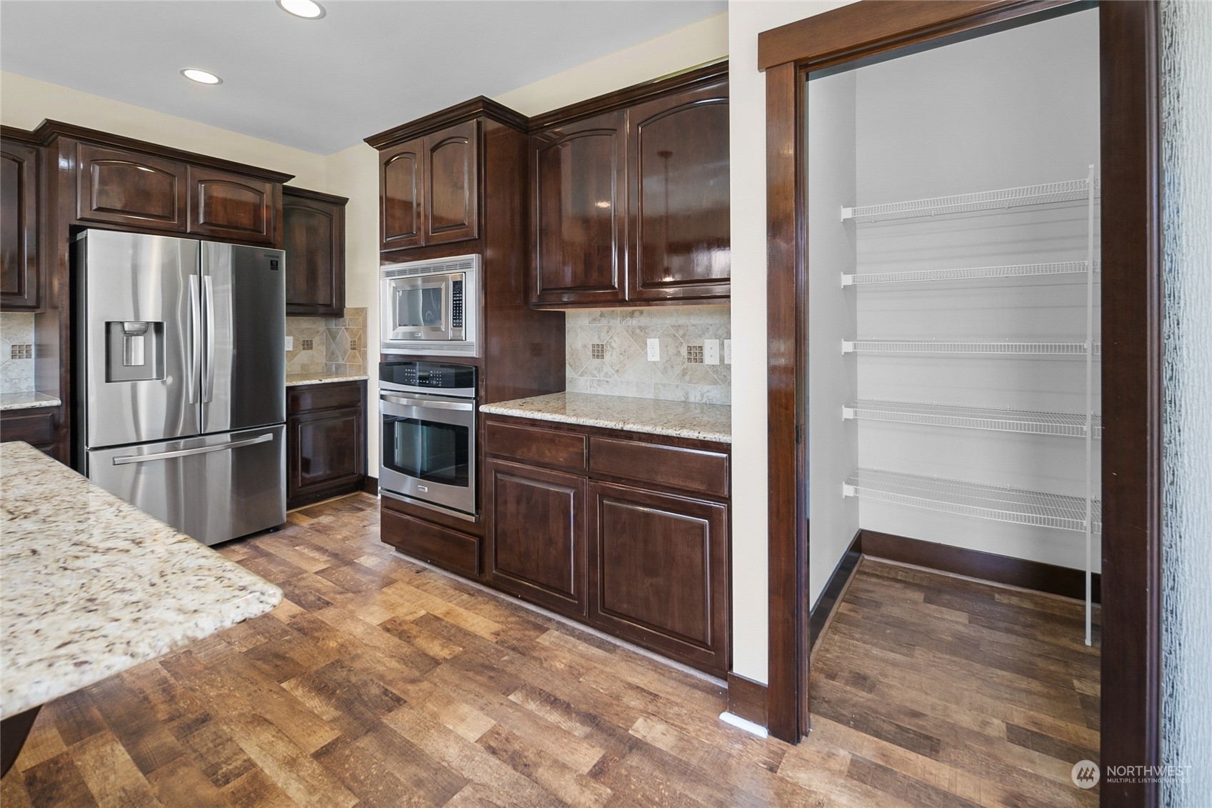 3110 216th Place Southeast Bothell, WA 98021 - Photo 16 of 37 a kitchen with granite countertop stainless steel appliances and refrigerator
