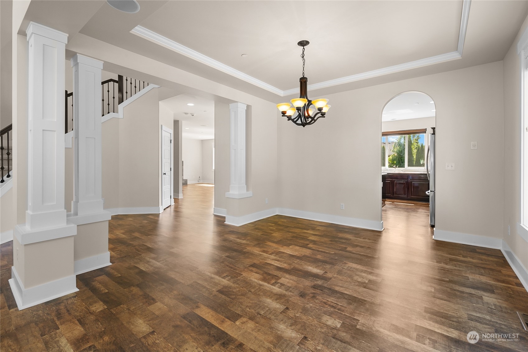 3110 216th Place Southeast Bothell, WA 98021 - Photo 9 of 37 a view of an empty room with wooden floor and chandelier