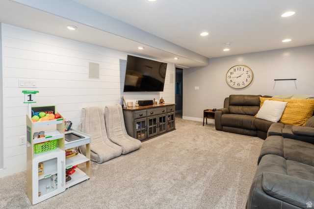 972 West 2840th Street South Logan, UT 84321 - Photo 21 of 46 Recreational living area featuring wall-mounted television, recessed lighting, white shiplap accent wall, and plush carpet flooring