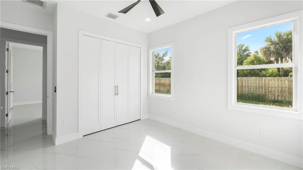 1687 19th Street Southwest Naples, FL 34117 - Photo 15 of 50 an empty room with windows and closet