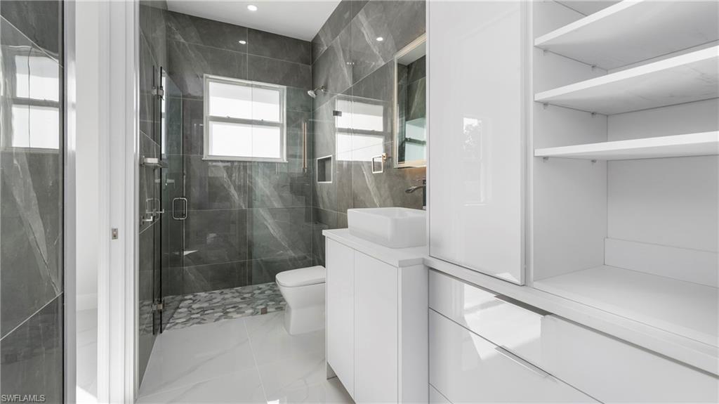 1687 19th Street Southwest Naples, FL 34117 - Photo 24 of 50 Bathroom featuring vanity and a shower stall