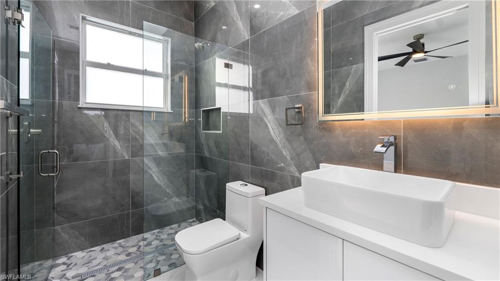 1687 19th Street Southwest Naples, FL 34117 - Photo 25 of 50 a bathroom with a sink a toilet and shower