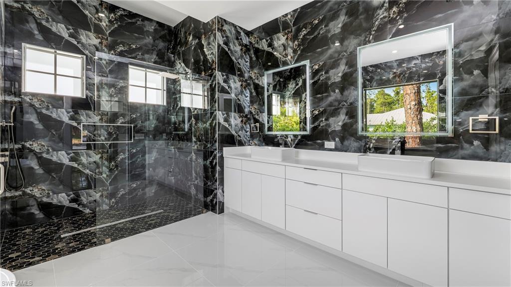 1687 19th Street Southwest Naples, FL 34117 - Photo 26 of 50 a bathroom with a sink and a mirror