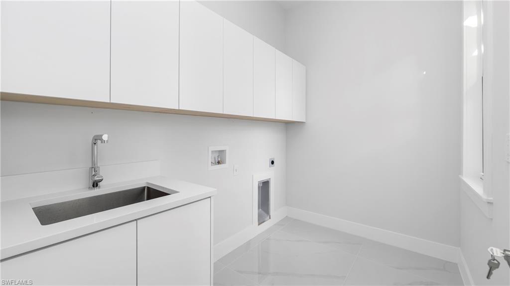 1687 19th Street Southwest Naples, FL 34117 - Photo 27 of 50 Laundry area featuring hookup for a washing machine, hookup for an electric dryer, cabinet space, and light marble finish flooring