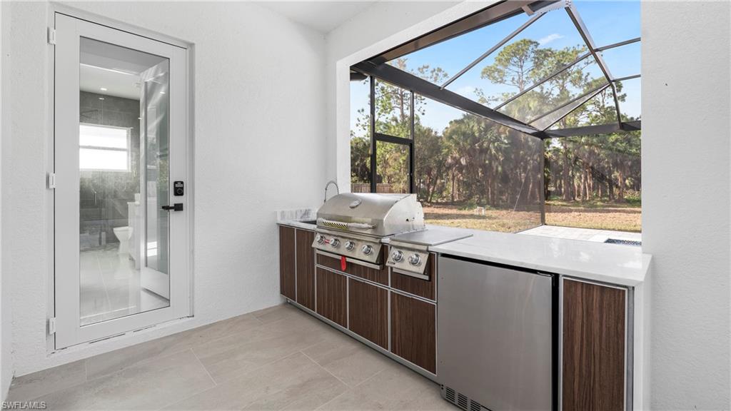 1687 19th Street Southwest Naples, FL 34117 - Photo 32 of 50 a kitchen with stainless steel appliances granite countertop a stove and a sink