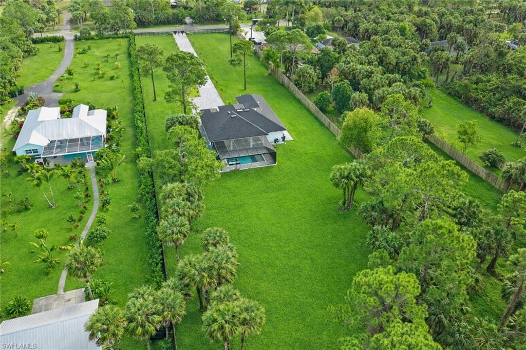 1687 19th Street Southwest Naples, FL 34117 - Photo 4 of 50 an aerial view of residential houses with outdoor space and trees