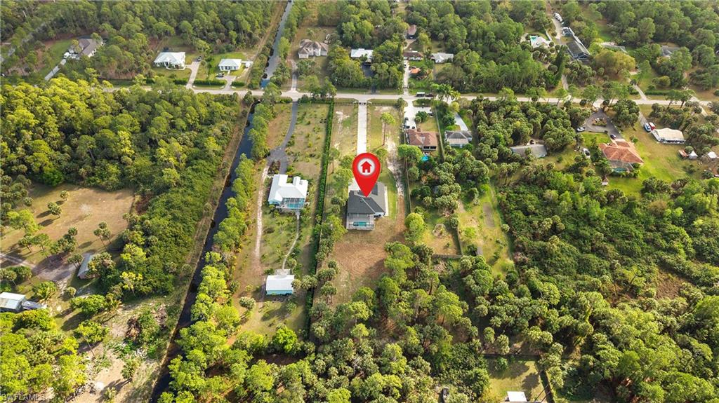 1687 19th Street Southwest Naples, FL 34117 - Photo 44 of 50 Aerial view of property and surrounding area with a heavily wooded area