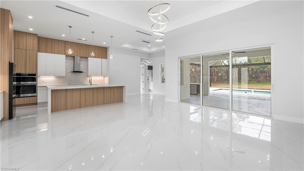 1687 19th Street Southwest Naples, FL 34117 - Photo 48 of 50 a large kitchen with a large window and stainless steel appliances