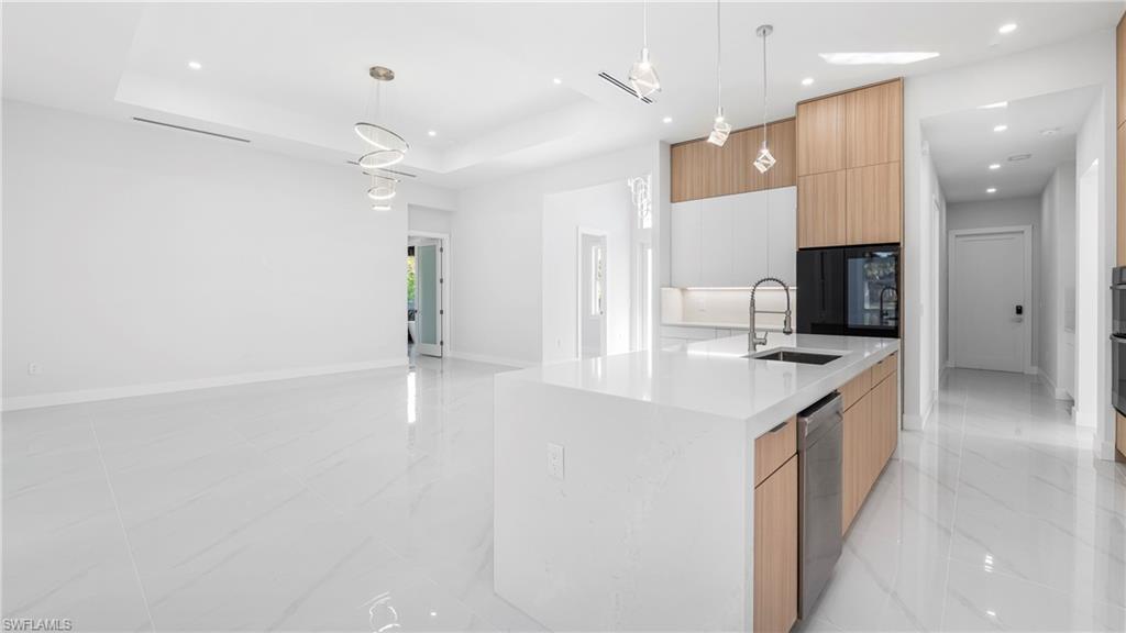 1687 19th Street Southwest Naples, FL 34117 - Photo 7 of 50 Kitchen with modern cabinets, white cabinetry, brown cabinets, and recessed lighting